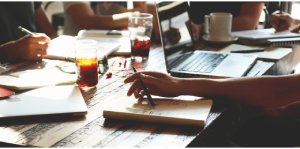 Close up of table with notebooks and a laptop